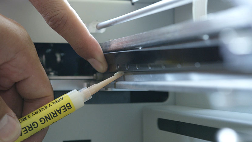 Apply a small amount of bearing grease to the top of the bearing rail. Applying bearing grease to the bottom of the bearing rail.