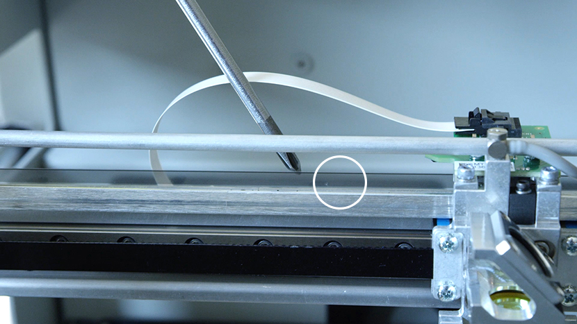 The encoder strip helps the machine achieve accurate positioning. Close-up of the linear encoder strip.