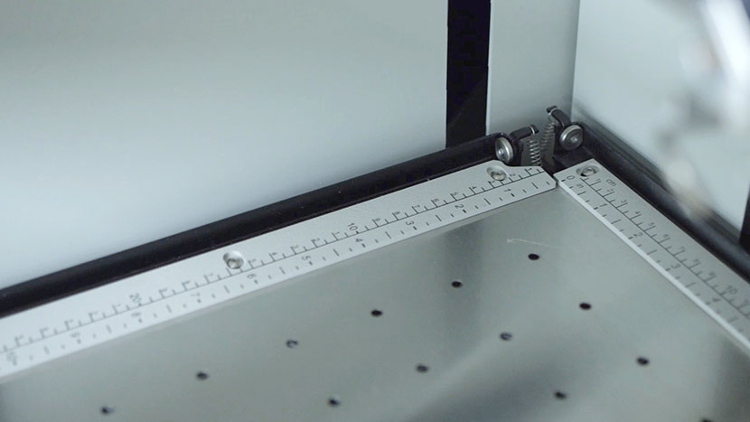 The linear guide rules help with placement and securing thing materials. The linear guide rulers along the side and top of the engrvaing table.