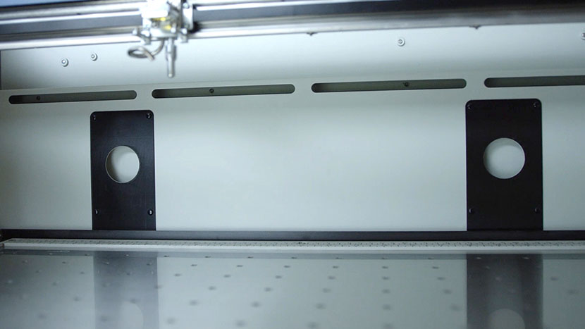 The exhaust slots remove dust and debris, while the exhaust holes create vacuum suction beneath the table. The exhaust slots and holes on the interior of the machine.