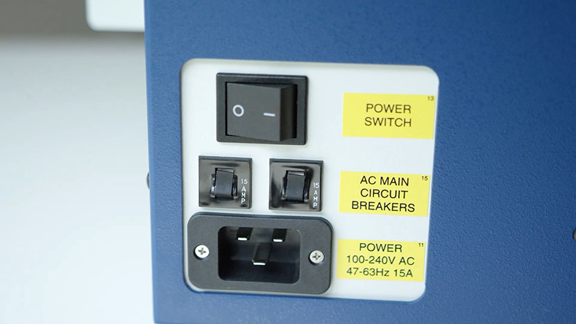 Next to the main power switch, you'll find the plug for the machine's power cord. The power switch, plug, and circuit breakers.