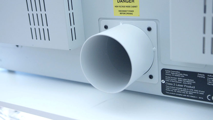 The exhaust plenum directs dust and debris out of the system. The exhaust plenum on the back of the machine.