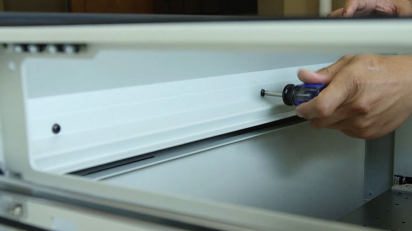 Remove the three screws securing the centers of the interior panels Removing the three screws that secure the centers of the interior panels