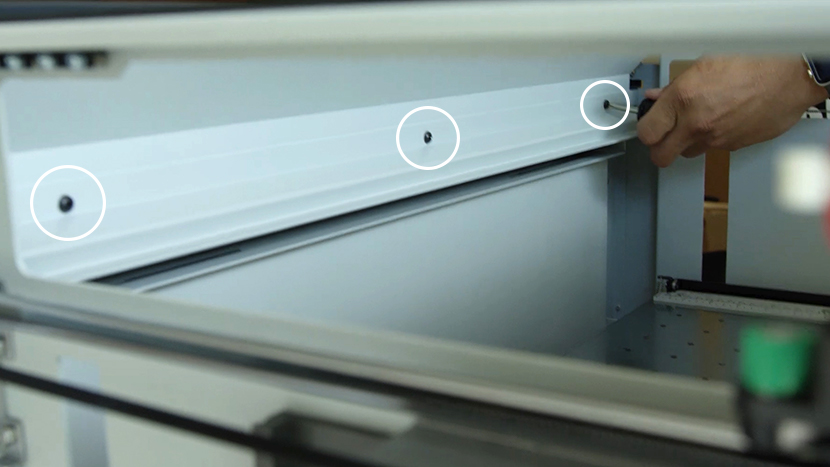 Insert the three center screws to secure both panels The three screws that secure the interior panels