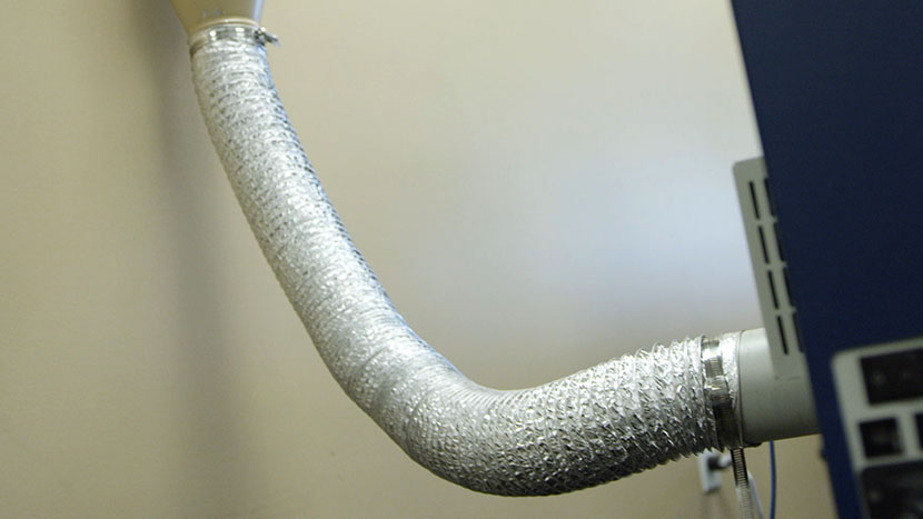 Air duct tubing should be kept as short as possible to increase air flow. Flexible metal ducting connecting the exhaust port of the laser to the building's ventilation system.