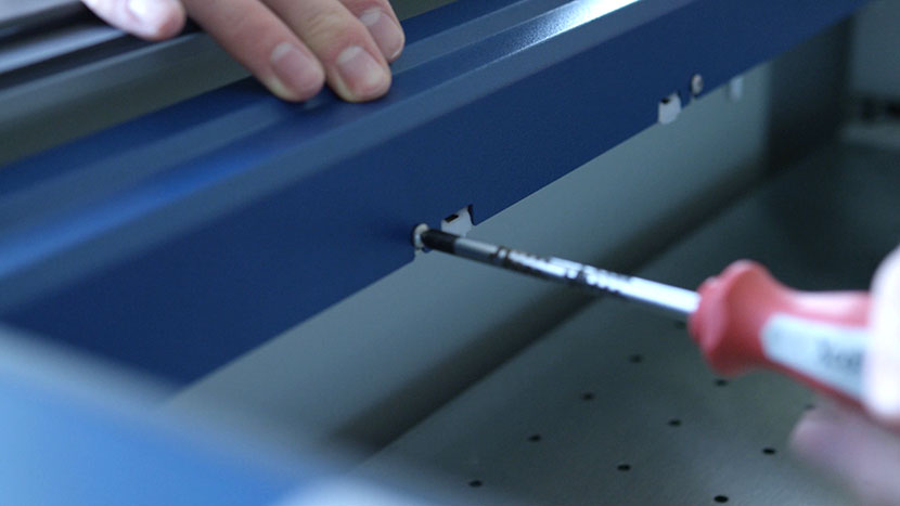 Loosen the screws on the front of the X-Axis Assembly. Loosening the screws on the front of the X-Axis Assembly.