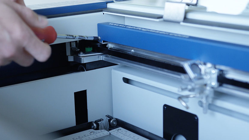 Loosen the screws on the back of the X-Axis Assembly. Loosening the screws on the back of the X-Axis Assembly.