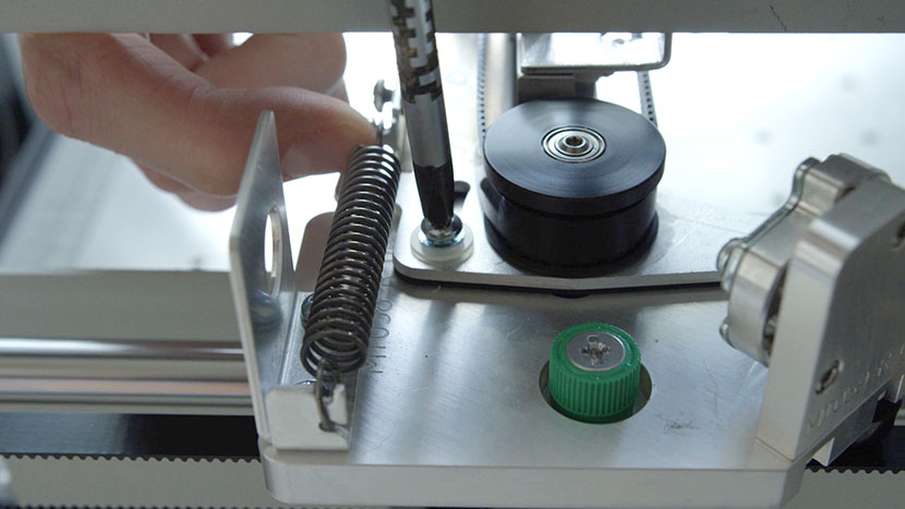 Hold the sliding plate to the right hand side of the engraver and tighten the screw Holding the sliding plate to the right hand side of the engraver and tightening the screw.