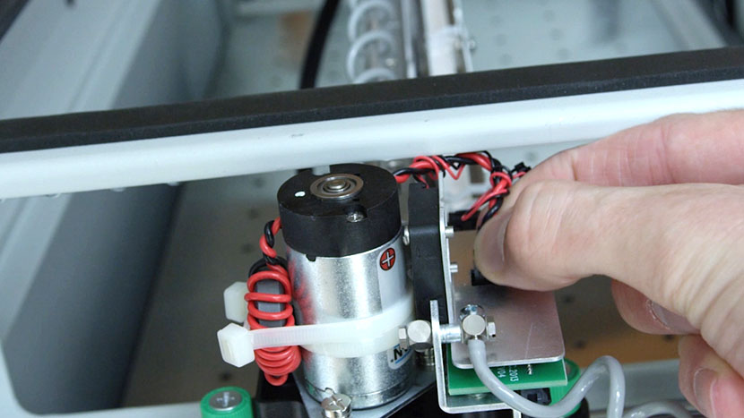 Unplug the two black connectors from the circuit board. Unplugging the two black connectors from the circuit board.