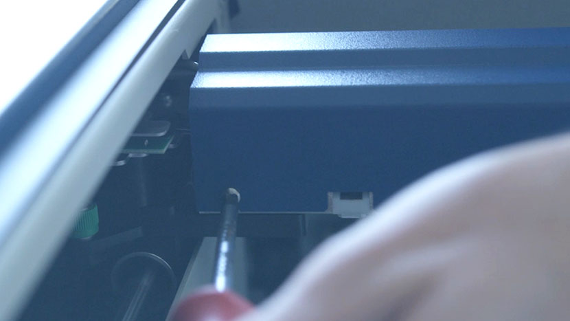 Tighten the screws on the back of the X-Axis Assembly. Tightening the screws on the back of the X-Axis Assembly.