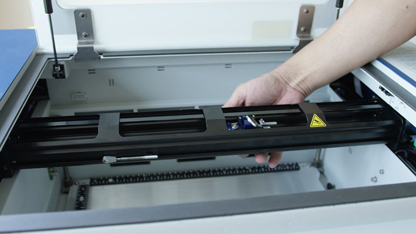 Move the X-Axis Assembly to the center of the machine and the lens carriage to the center of the axis. The lens carriage positioned near the center of the machine.