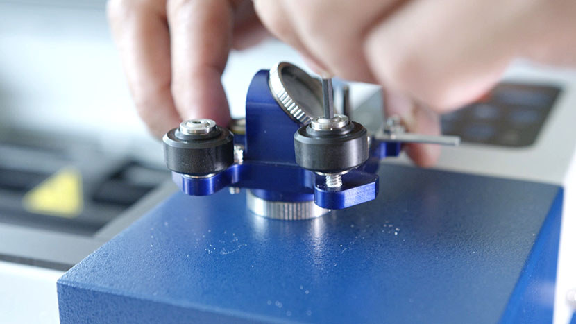 Install the new rollers, tightening them securely. Screwing in the new rollers.