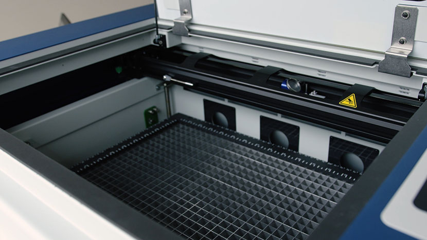 The X-Axis Assembly begins at the back of the machine to provide easy access to the table. The interior of the Zing laser machine.