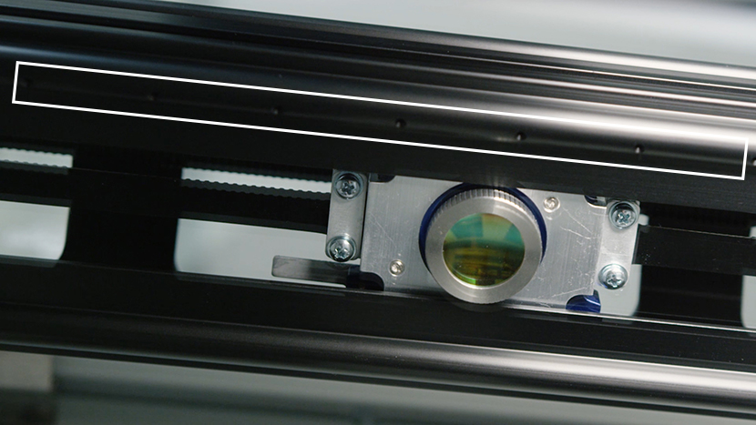 The Air Assist curtain helps give you clean cuts and engravings. The Air Assist holes on the underside of the X-Axis Assembly.