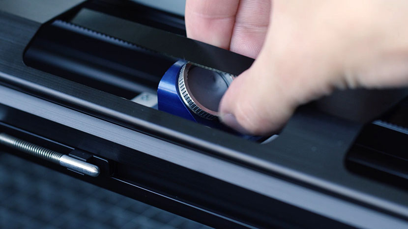 The lens assembly features easily accessible mirrors. Unscrewing the top lens assembly mirror.