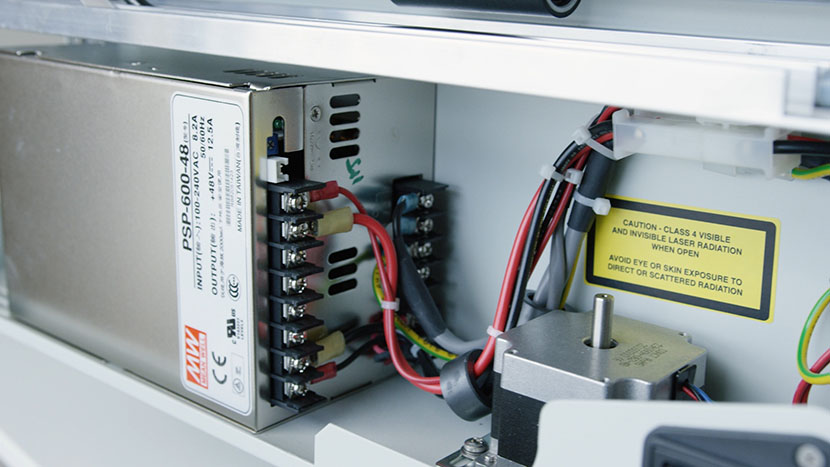 The lower section houses the DC power supply and the Z-Motor (Table Motor). Close-up of the power supply and Z-Motor.