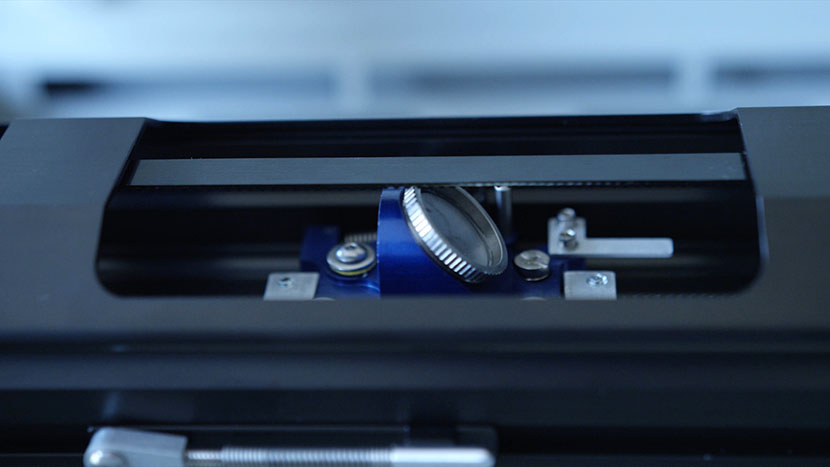 Other components of the optics system are exposed and more vulnerable to dust and debris. The mirror of the lens assembly.