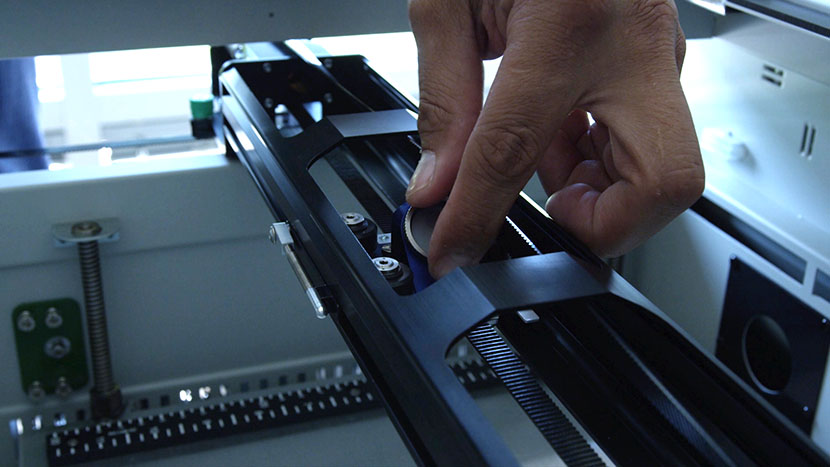 Unscrew the mirror from the top of the lens assembly. Unscrewing the lens assembly mirror.