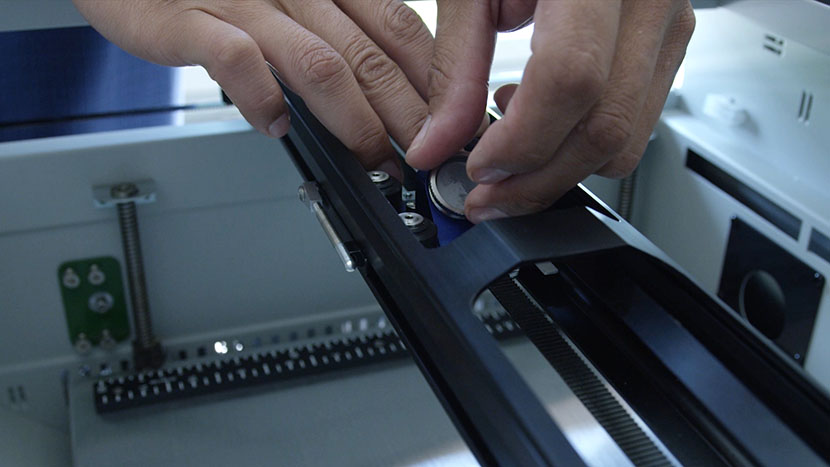 Screw the lens assembly mirror back in. Screwing in the lens assembly mirror.