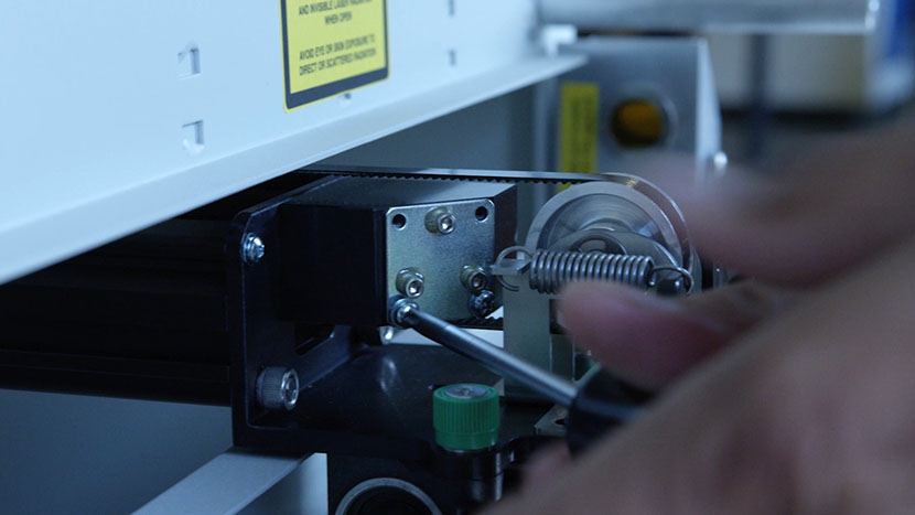 Remove the mirror at the end of the x-axis assembly. Unscrewing the mirror from the end of the x-axis assembly.