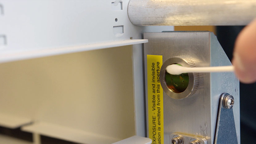 Gently clean the outside of the window at the top of the periscope. Cleaning the window at the top of the periscope.