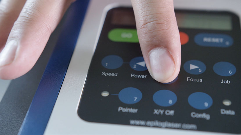 Lower the table via the control panel. Finger pressing the down arrow button on the display panel.