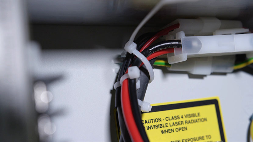 Tighten the zip tie aroun dthe cords. The power supply cords secured in a zip tie.