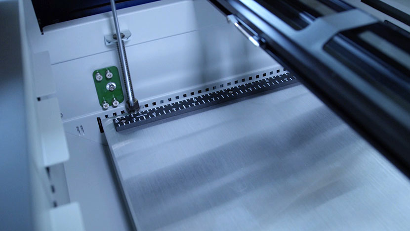 Screw in the table's four corner screws. Tightening the back right table screw.