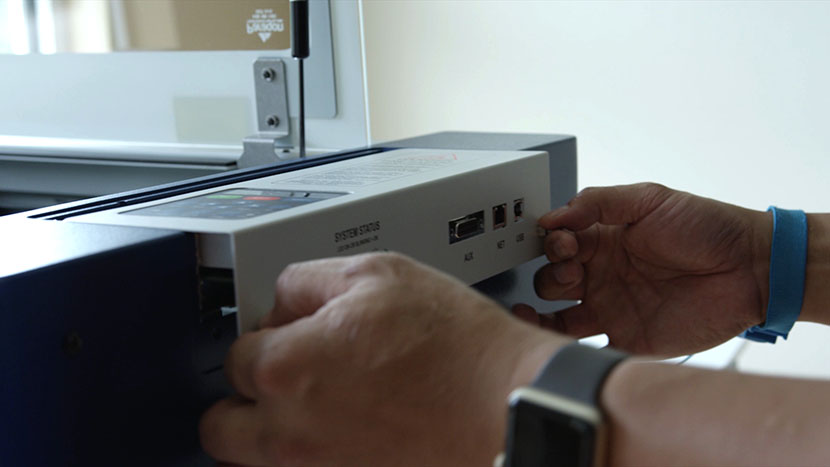 Pull the controller away from the engraver. Pulling the display panel out of the machine.