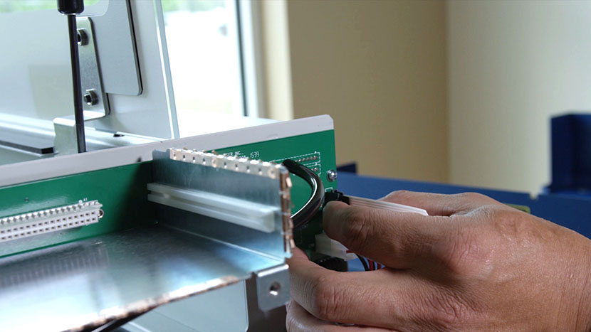 Remove the flex cable. Removing the flex cable in the back right of the machine.