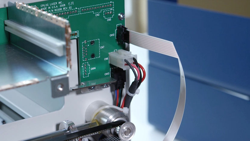 Install the white ribbon cable. The white ribbon cable plugged in.