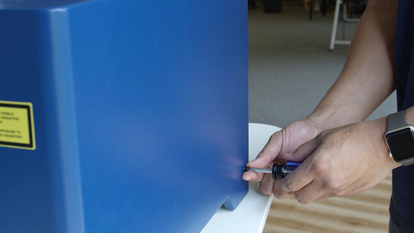 Insert the left side panel's side screws. Screwing in one of the left panel's side screws.