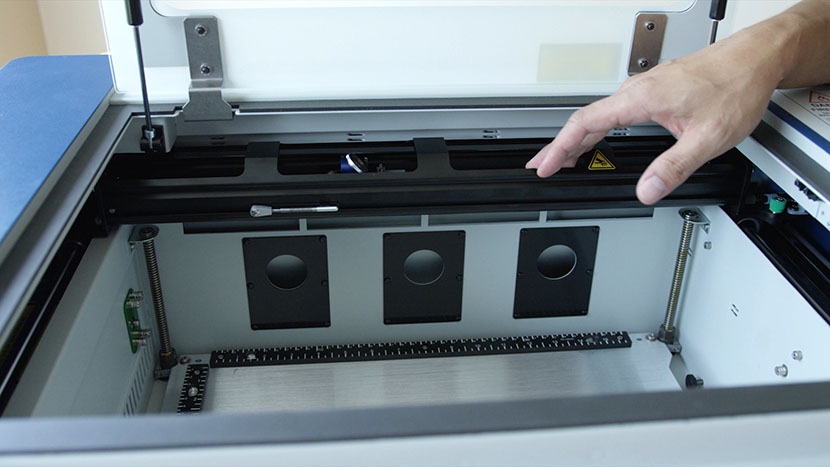 Move the x-axis assembly to the back of the machine. The x-axis assembly positioned at the back of the machine.