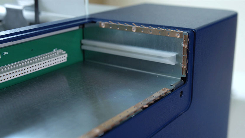 Be sure the copper strips stay in place. A close-up of the copper strip inside the control housing.