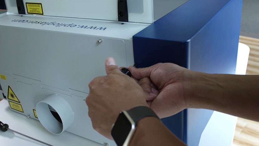 Remove the screw on the back side of the panel. Removing the screw on the left panel's back.