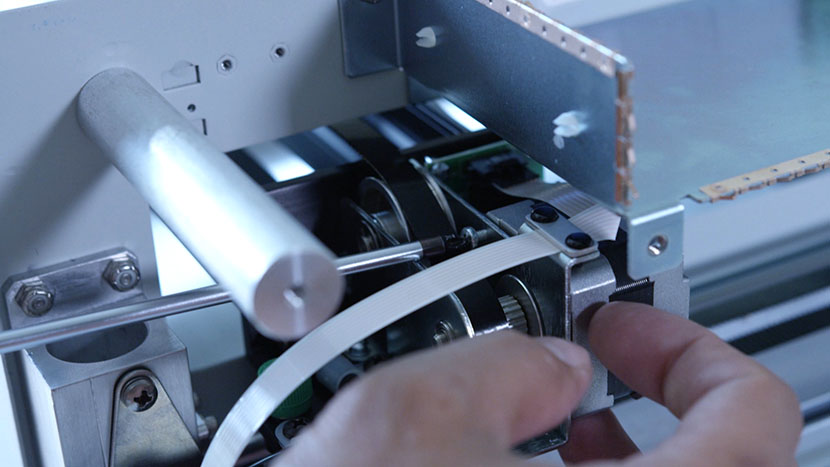 Remove the top screw securing the x-motor. Removing the top screw from the x-motor.