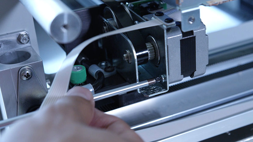 Remove the bottom screw securing the x-motor. Removing the bottom screw from the x-motor.