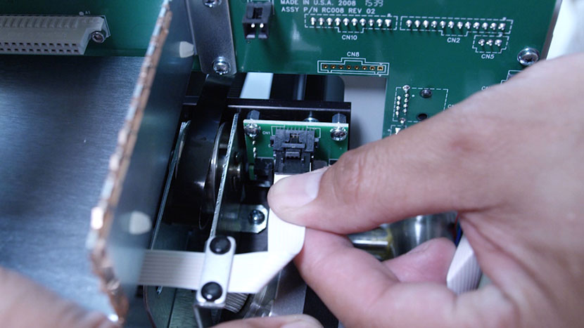 Plug in the flex cable. Preparing to plug in the motor's flex cable.