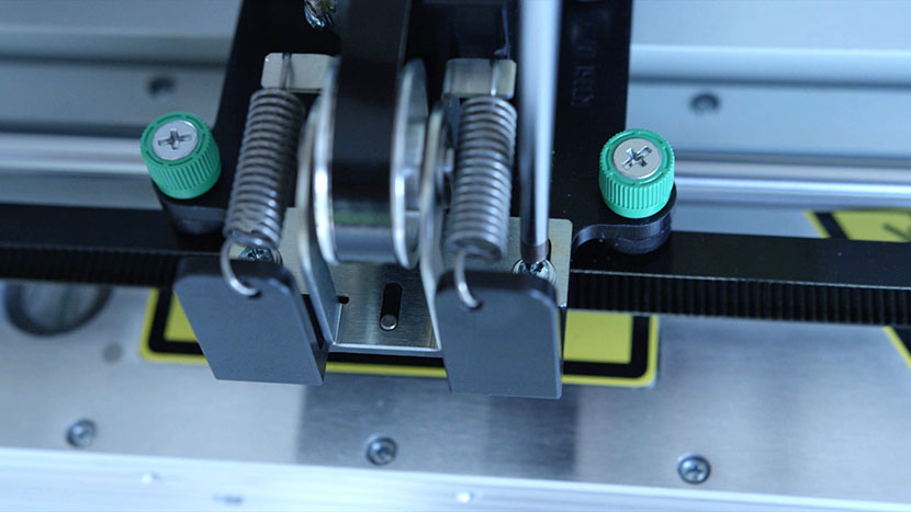 Loosen the two idler bracket screws. The idler bracket before the springs have been freed.