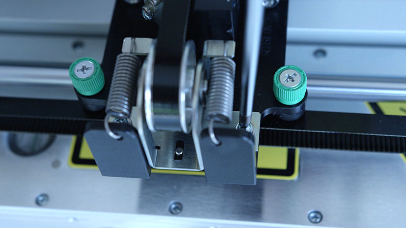 Once the springs have expanded and pushed the idler bracket out, tighten the idler bracket screws. The idler bracket after the springs have been freed and the idler has moved.