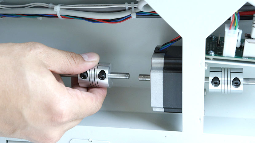 Slide the left drive coupler away from the Y-Motor. The left drive coupler slid to the left.