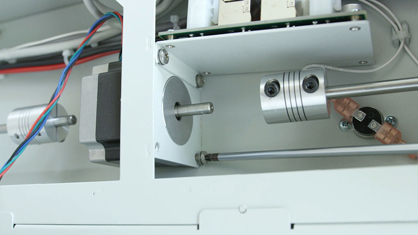 Remove the four Y-Motor mounting screws. Unscrewing the Y-Motor mounting screws.