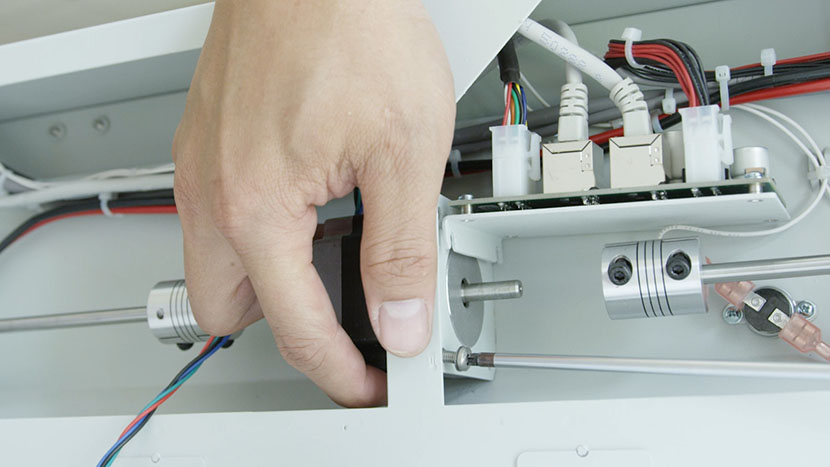 Install the new Y-Motor by inserting the four mounting screws. Installing the Y-Motor.