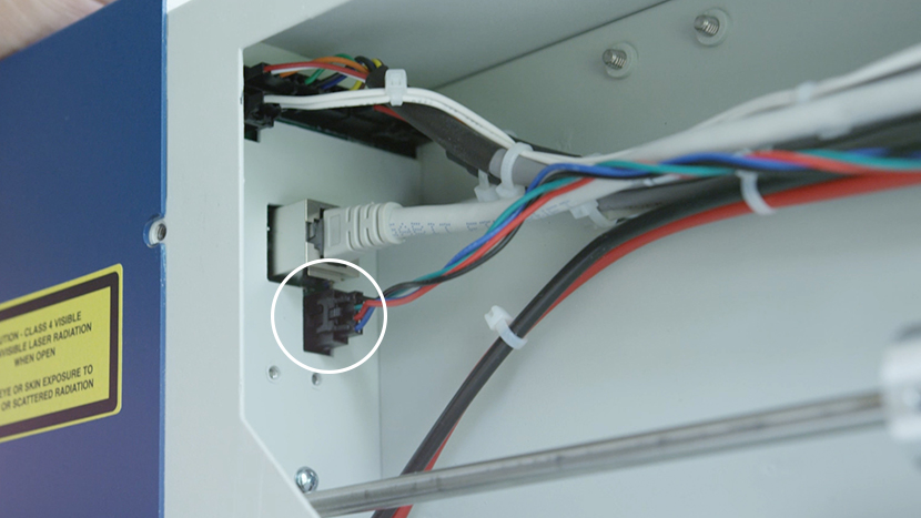 Reconnect the Y-Motor electrical connection. The Y-Motor electrical connection plugged in to the left side of the rear compartment.