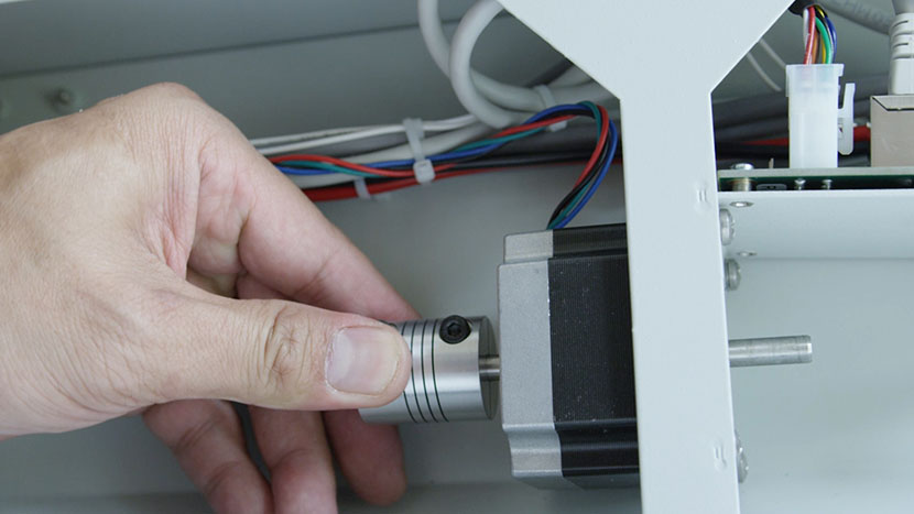 Slide the drive couplers back into place, leaving 1/4 inch clearance between the couplers and the motor. Sliding the left coupler back into place.