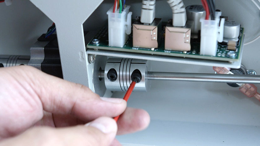 Tighten the hex screws on the right drive coupler. Tightening the hex screws on the right drive coupler.